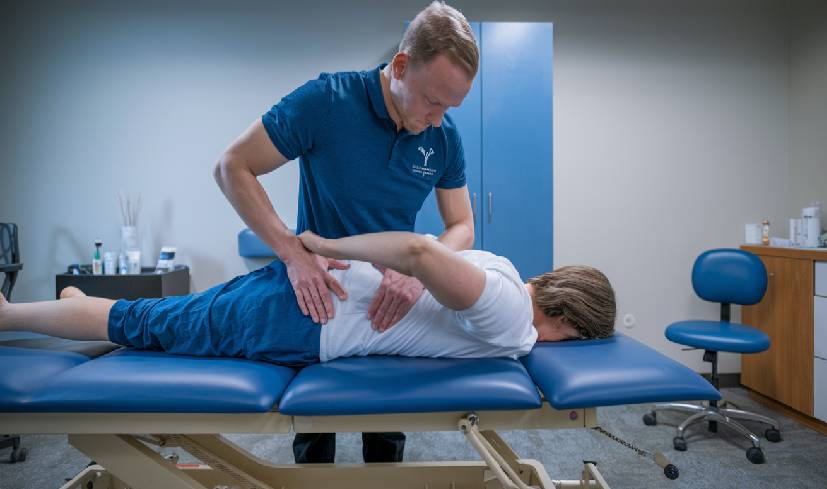 physiotherapist providing manual therapy for back pain